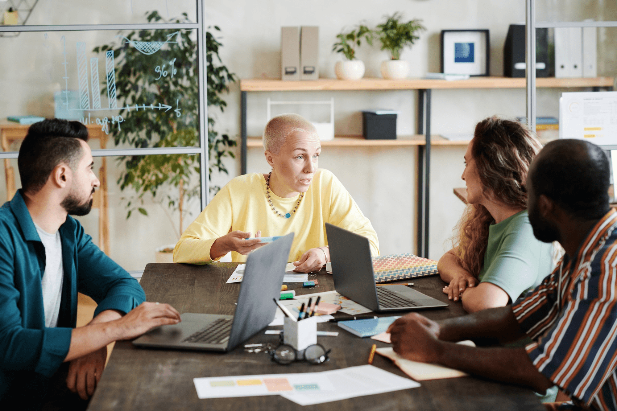 Colleagues discussing a project around a meeting table